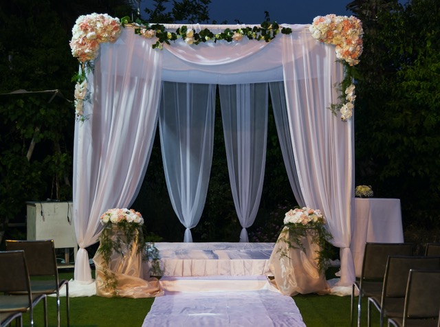 This is a stylish chuppah, but the wide descending drapes at the front, will hide the parents from being viewed by the guests.
